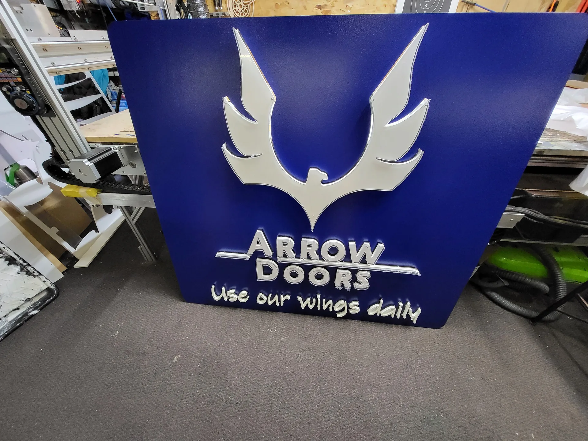 3D sign Arrow Doors company blue
