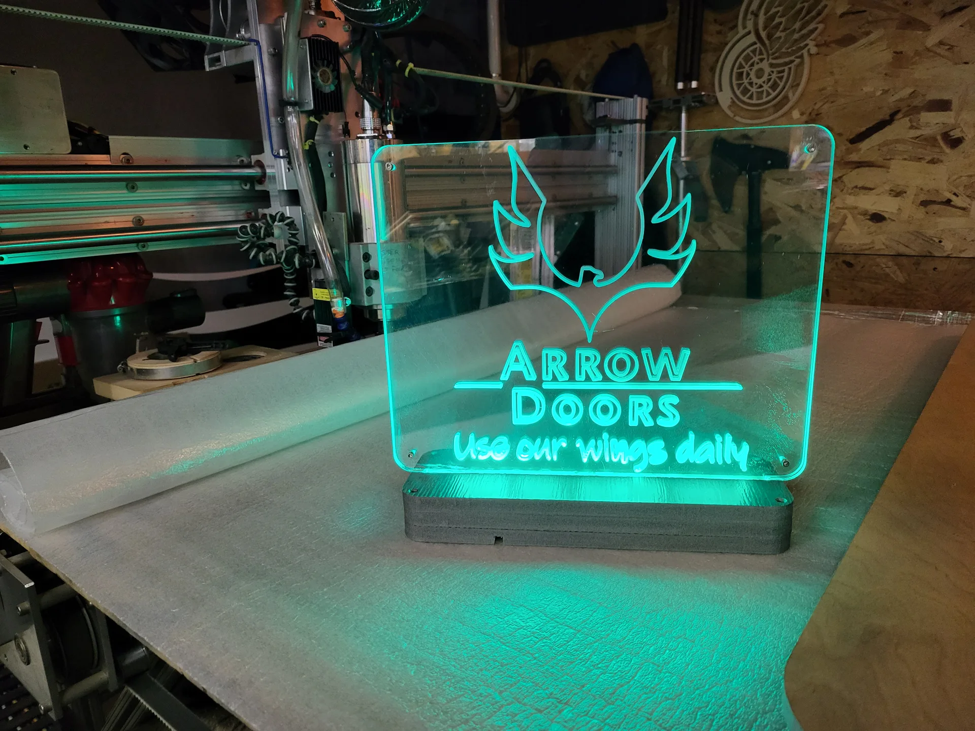 Edge lit acrylic sign Arrow Doors green